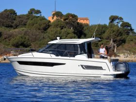 A couple enjoys a romantic moment aboard a Merry Fisher boat, surrounded by serene waters and lush greenery — perfect for intimate getaways.