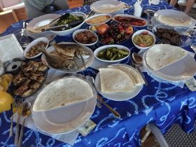 A beautifully arranged table featuring a variety of delicious seafood and snacks, perfect for onboard dining experiences.