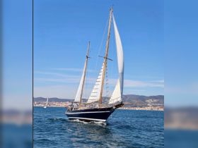 A beautiful sailboat glides through the water, showcasing its elegant sails and classic design — perfect for sailing enthusiasts and scenic ocean adventures.