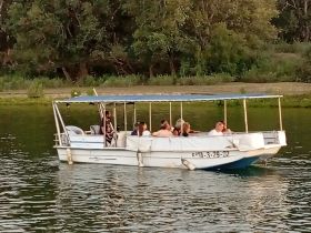 A lively group enjoys a boat ride on the water, perfect for social gatherings and fun outings with friends.