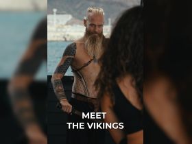 A captivating moment featuring a Viking-themed experience on a boat, showcasing a character in traditional attire, perfect for adventure seekers and cultural enthusiasts.