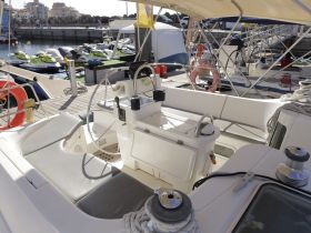 A well-appointed helm area of a boat featuring comfortable seating and essential controls, perfect for navigating the waters.