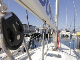 Close-up view of the helm area on a sailboat, showcasing the rigging and equipment, perfect for sailing enthusiasts and those interested in boat interiors.