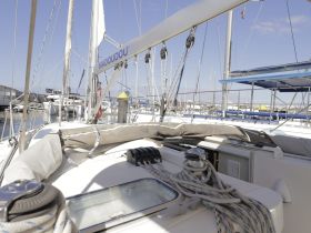 A detailed view of the helm area on a sailboat, showcasing the console and rigging, perfect for sailing enthusiasts and charter planning.