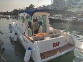 A sleek yacht docked at the marina, showcasing its elegant design and spacious deck, perfect for leisurely outings on the water.