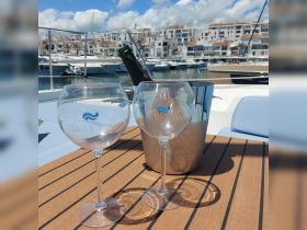 A stylish setup featuring champagne and elegant glasses on a boat deck, perfect for a relaxing day on the water or a celebratory toast.