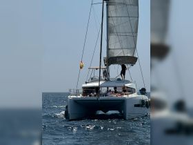 A lively catamaran sails through the open water with guests enjoying the sun — perfect for group outings and sailing adventures.