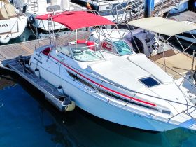 A well-maintained yacht docked at the marina, showcasing its sleek design and vibrant red canopy — perfect for day trips or weekend getaways.
