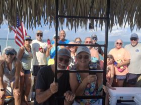 A lively group of friends enjoys a fun day on the water, celebrating together aboard a boat — perfect for memorable outings and gatherings.