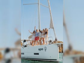 A joyful group of friends celebrates aboard a yacht, capturing the essence of fun and camaraderie on the water.