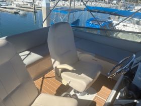 Comfortable flybridge seating with the captain
