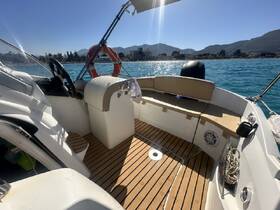 A well-appointed helm area inside a boat, featuring comfortable seating and a clean layout, perfect for navigating the waters.