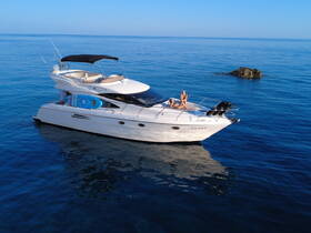 Two women enjoy sunbathing on a luxurious yacht, surrounded by calm blue waters — a perfect scene for relaxation and summer adventures.
