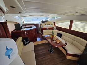 A beautifully designed interior of a yacht featuring a cozy seating area and dining table, perfect for relaxing and enjoying meals while on the water.