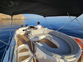 A well-appointed helm area on a boat, featuring comfortable seating and a clear view of the serene waters, perfect for navigating coastal adventures.