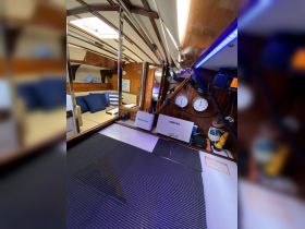 Interior view of a boat's helm area featuring modern navigation equipment and comfortable seating, ideal for a relaxing day on the water.