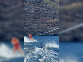A thrilling moment captured of a person water skiing in the ocean, showcasing the excitement and adventure of water sports.