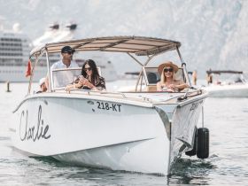 A lively group enjoys a day on the water aboard a stylish boat, capturing moments of summer fun and relaxation.
