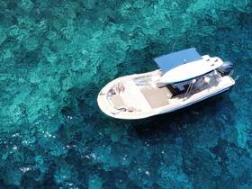Aerial view of the 'Cristal Sea' speedboat gliding over crystal-clear turquoise waters, showcasing the beauty of boating adventures.