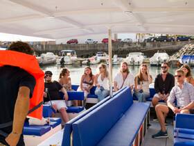 A lively group enjoys drinks aboard a boat, creating a festive atmosphere perfect for celebrations and social gatherings on the water.