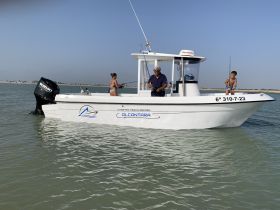 A family enjoys a fishing trip on a boat, with children actively participating in the fun. This scene captures the joy of outdoor adventures on the water.