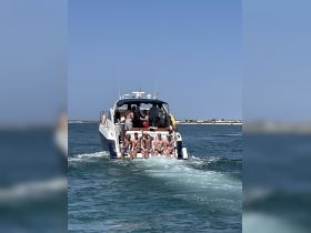 A lively group enjoys a fun day on the water aboard a boat, showcasing the perfect atmosphere for celebrations and group outings.