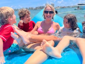 A joyful moment with a family enjoying the water, laughing and playing together — perfect for capturing fun summer memories on the water.