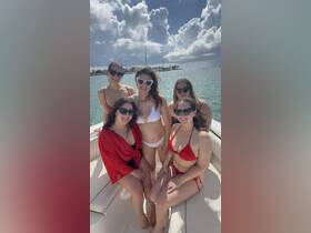 A lively group of friends enjoys a sunny day on the boat, perfect for celebrations and memorable outings on the water.