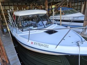 A well-equipped boat interior showcasing the helm and cabin area, perfect for fishing or leisure outings.