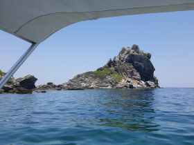 A picturesque view of a rocky island surrounded by calm waters, perfect for exploring coastal landscapes and enjoying serene boat trips.