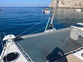 A clear view of a catamaran's deck with a stunning blue ocean backdrop, perfect for enjoying a day on the water.