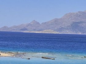 A scenic view of mountains and water, though the image lacks clarity and detail.