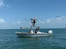 A group enjoys a day on the water aboard a motorboat, showcasing the fun and adventure of boating in clear blue waters.