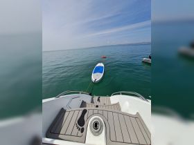 A paddleboard is anchored in calm waters, showcasing the perfect setup for a day of relaxation and water activities on the boat.