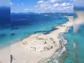 A stunning aerial view of a picturesque island with white sandy beaches and crystal-clear waters, perfect for exploring and enjoying nature's beauty.