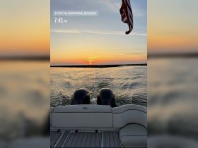 A stunning sunset view from the back of a boat, showcasing the tranquil waters and the silhouette of the landscape — perfect for evening cruises near Fort Pulaski National Monument.