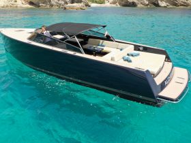 A sleek Van Dutch 40 yacht glides through crystal-clear waters, showcasing its elegant design and luxurious seating — perfect for stylish outings on the water.