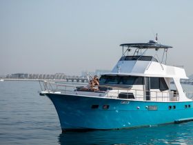 A couple celebrates with champagne aboard a beautiful yacht, enjoying a perfect day on the water — ideal for romantic getaways or special occasions.
