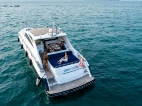 A group of friends enjoys a relaxing day on a luxurious yacht, soaking up the sun and savoring the beautiful ocean views — perfect for a memorable day on the water.
