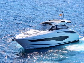A sleek yacht glides through sparkling blue waters, showcasing its elegant design and perfect for luxury cruising.