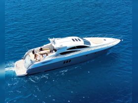 A luxurious yacht cruising through crystal-clear waters with guests enjoying the sun — perfect for a day of relaxation and adventure on the sea.