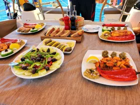 A beautifully arranged spread of gourmet dishes on a boat, showcasing a delightful dining experience with fresh ingredients and vibrant flavors, perfect for onboard meals.