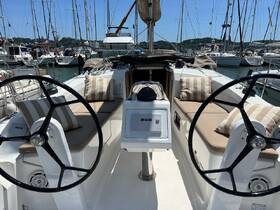 A well-appointed helm area of a sailboat featuring comfortable seating and modern navigation equipment, perfect for a day on the water.
