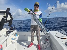 An angler proudly displays a large fish caught while deep-sea fishing, showcasing the thrill of ocean adventures. Perfect for fishing enthusiasts and adventure seekers.