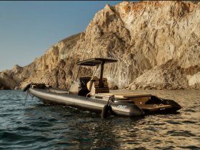 A sleek speedboat anchored near stunning rocky cliffs, showcasing the perfect vessel for coastal adventures and explorations.