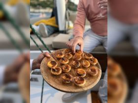 A beautifully arranged platter of pastries is served on a boat, perfect for enjoying gourmet snacks while cruising the waters.