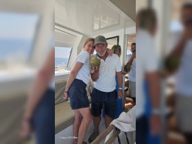 A joyful group enjoys drinks aboard a boat, capturing a moment of celebration and camaraderie in a stylish interior setting.