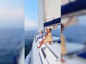 Three friends enjoy a sailing adventure, capturing moments of joy and camaraderie on the deck of a yacht — perfect for memorable outings on the water.