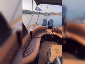 Interior view of a luxurious boat featuring stylish seating and helm area, perfect for comfortable cruising.
