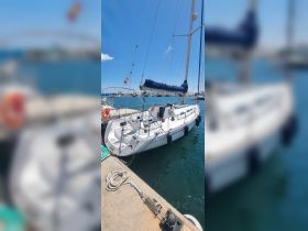 A sleek sailboat docked at the marina, showcasing its elegant design and ready for sailing adventures.